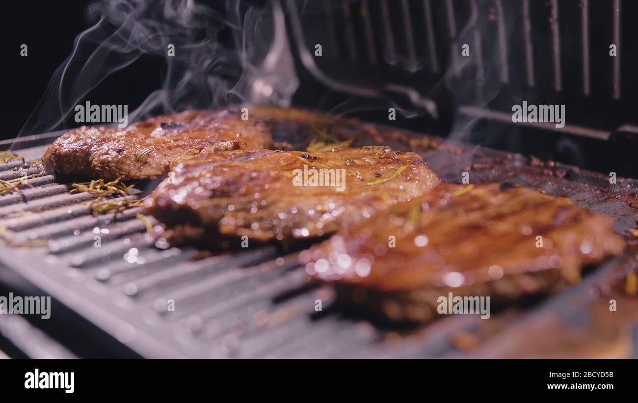 Delicious juicy meat steak cooking on grill. Prime beef fry on electric