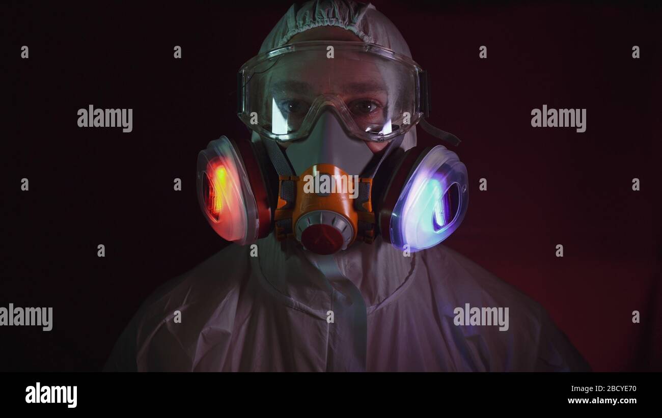 Man in protective costume suit, gas protect medical spray paint mask