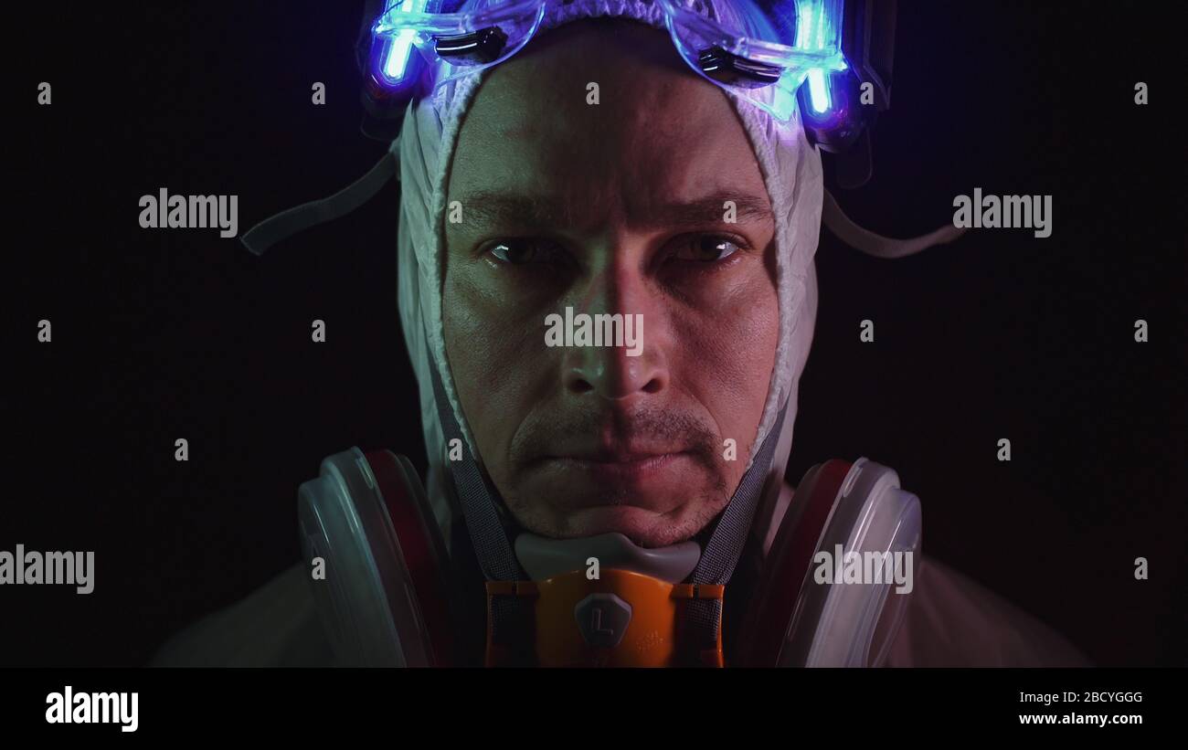 Man in protective costume suit, gas protect medical spray paint mask