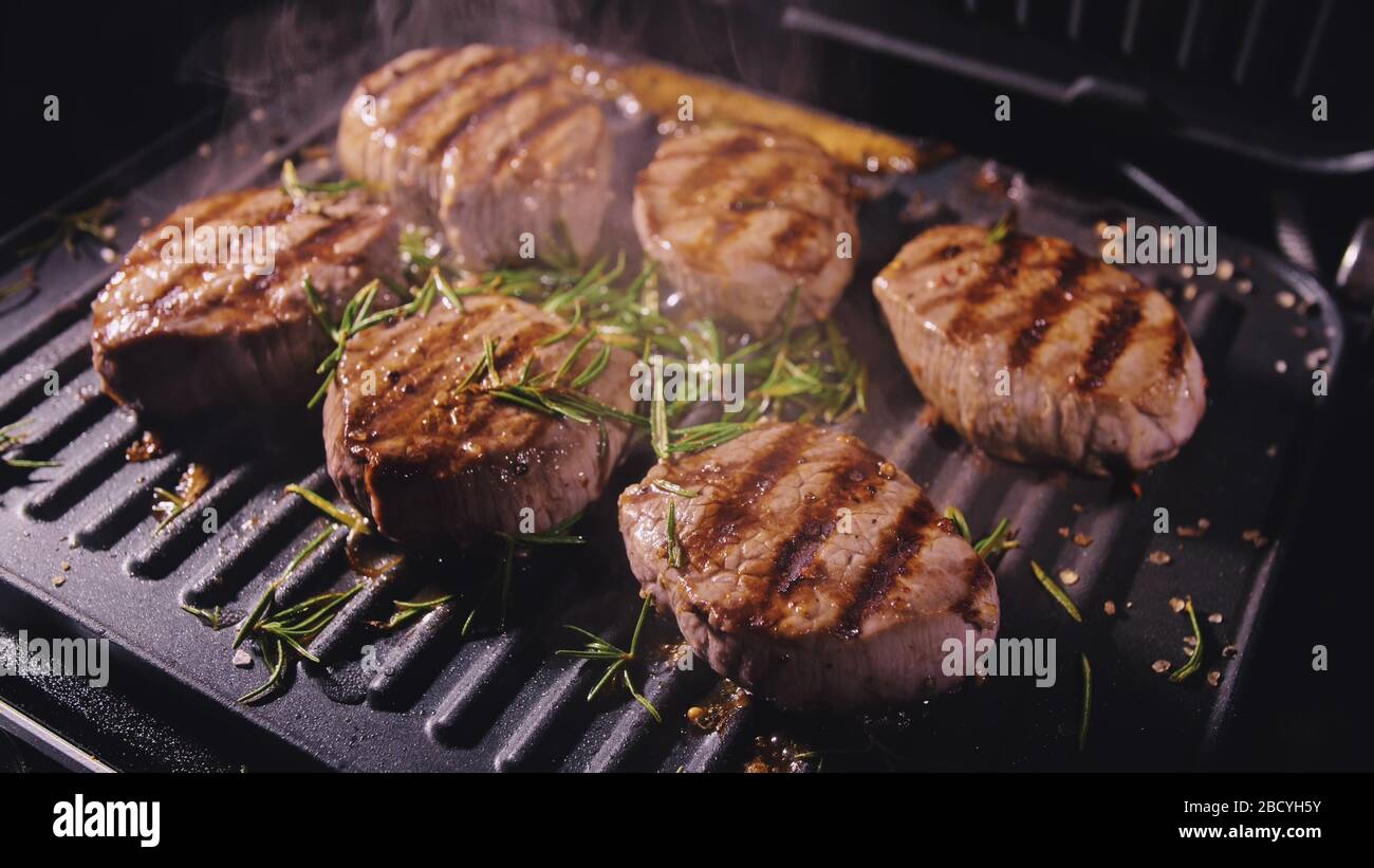 Delicious juicy meat steak cooking on grill. Prime beef fry on electric
