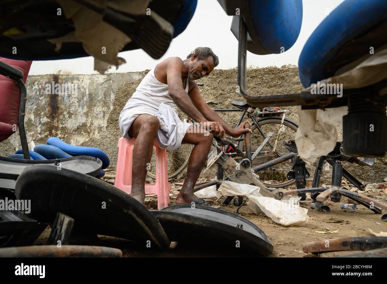 A chair-repair person plying his trade, Tuticorin , India Stock Photo