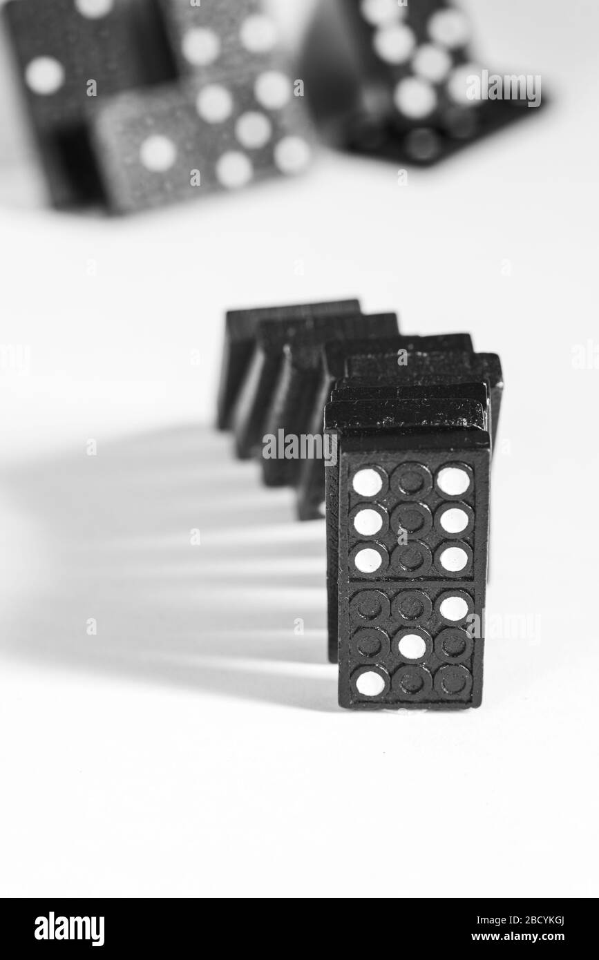 Black Domino blocks falling, isolated on white background Stock Photo