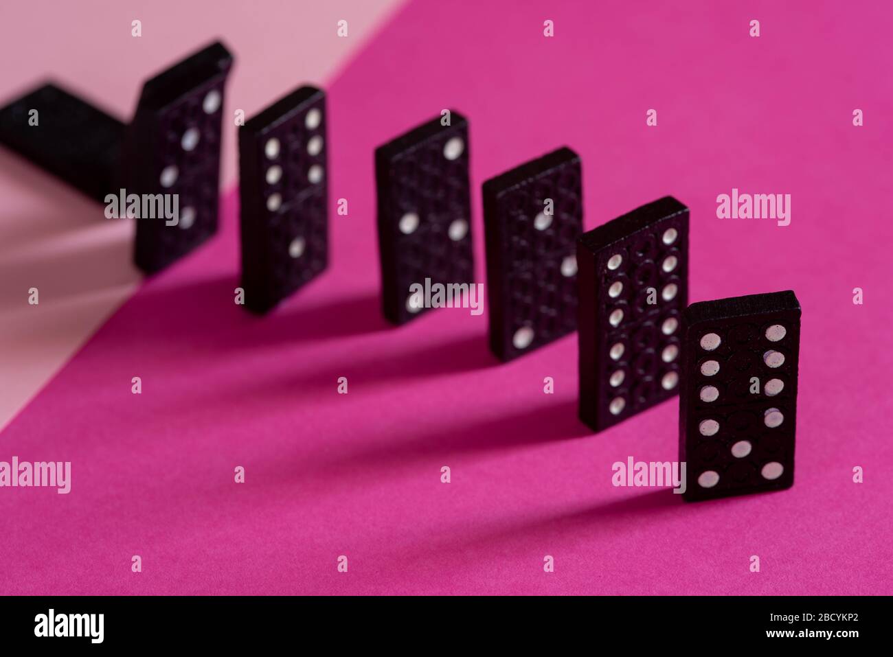 Black Dominoes game block in a row on a colored background Stock Photo -  Alamy