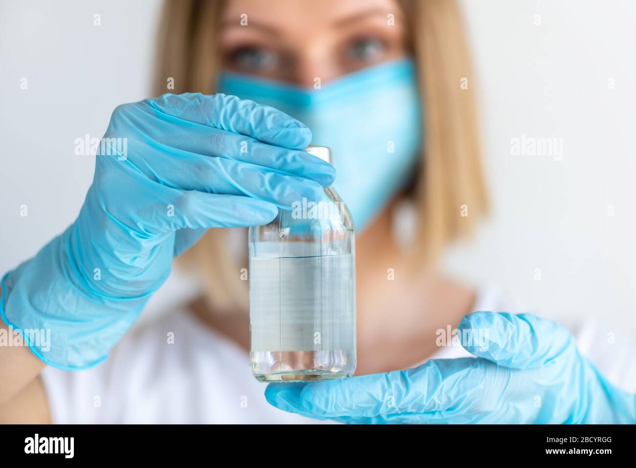 Bottle for injection in nurse hand. Medical glass vial for vaccination