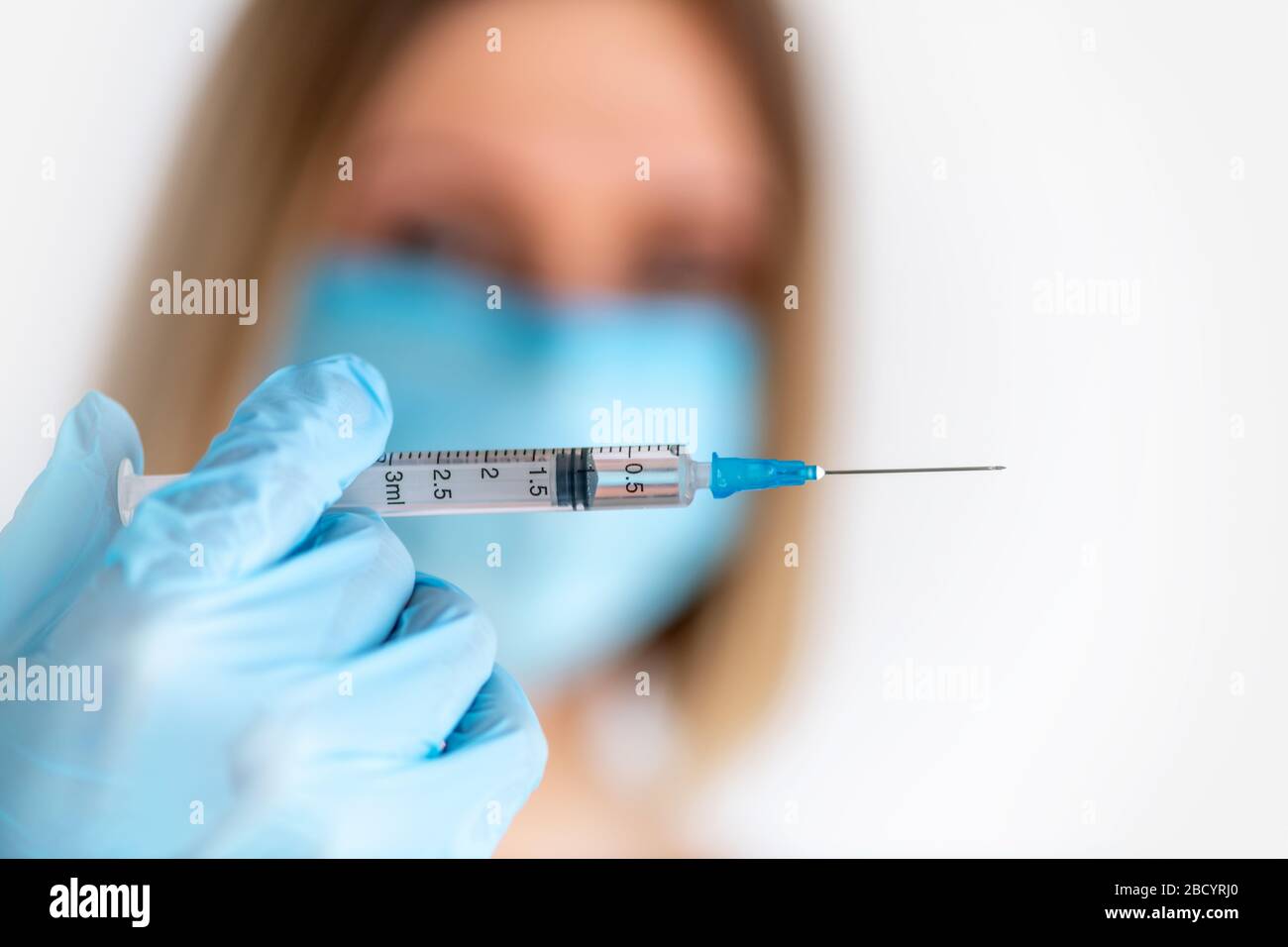 Syringe for injection in nurse hand. Medical glass vial for vaccination ...