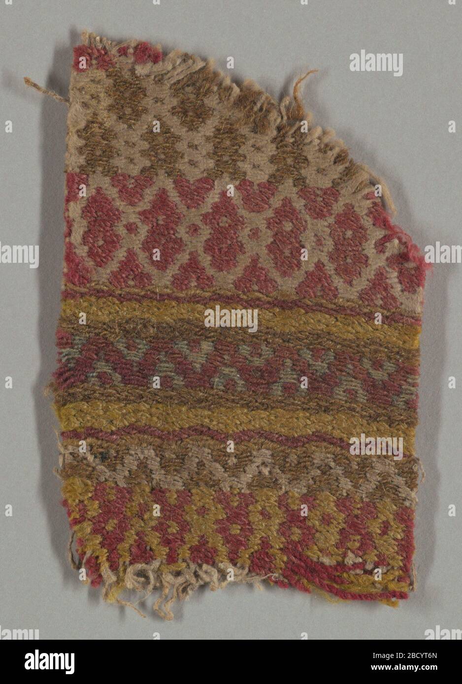 Textile. Research in ProgressCoarse wool and hand-spun linen in brown, yellow, red, and white. Patterning of simple geometric bands and lozenges. Patterned by weft floats that hide warps entirely. Textile Stock Photo