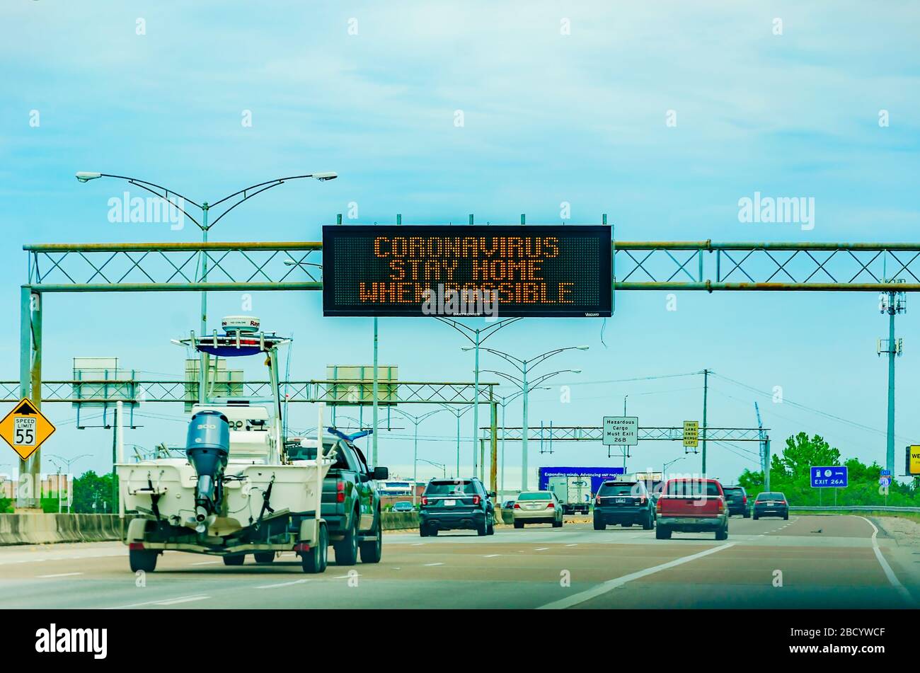 An electronic sign on Interstate 10 West encourages motorists to stay home during the COVID-19 pandemic, April 4, 2020, in Mobile, Alabama. Stock Photo