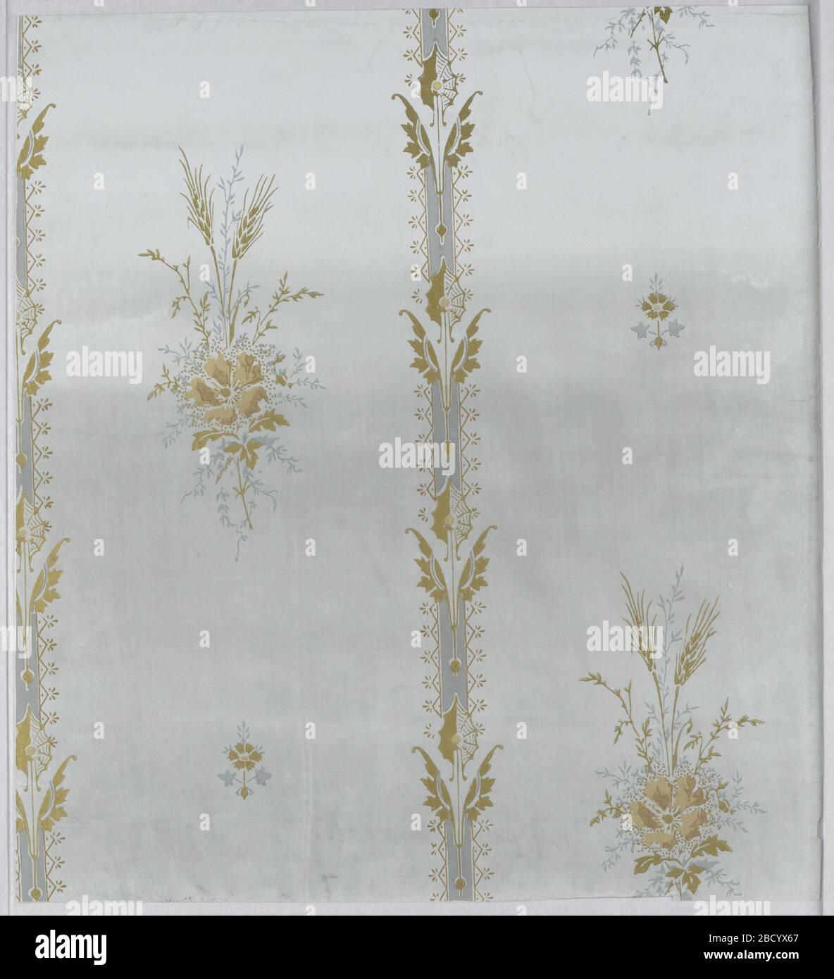 Sidewall. Pattern repeated in off-set vertical columns; two motifs repeated vertically; one a large bunch of foliage with two ears of wheat and a large flower; one a small stylized motif; vertical band between each column consisting of a repeated arrow-like symmetrical motif composed of ab Sidewall Stock Photo