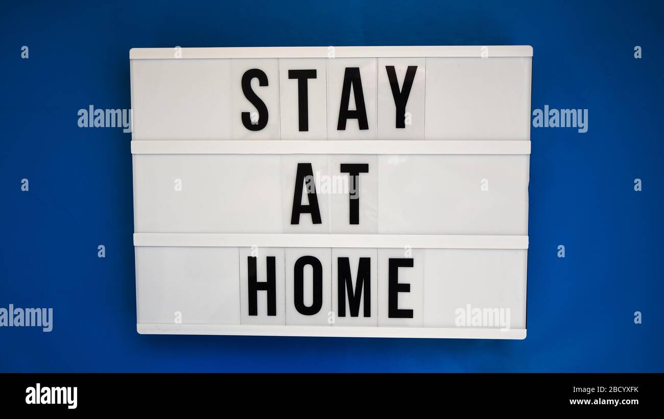 Lightbox with text STAY AT HOME on blue background Stock Photo