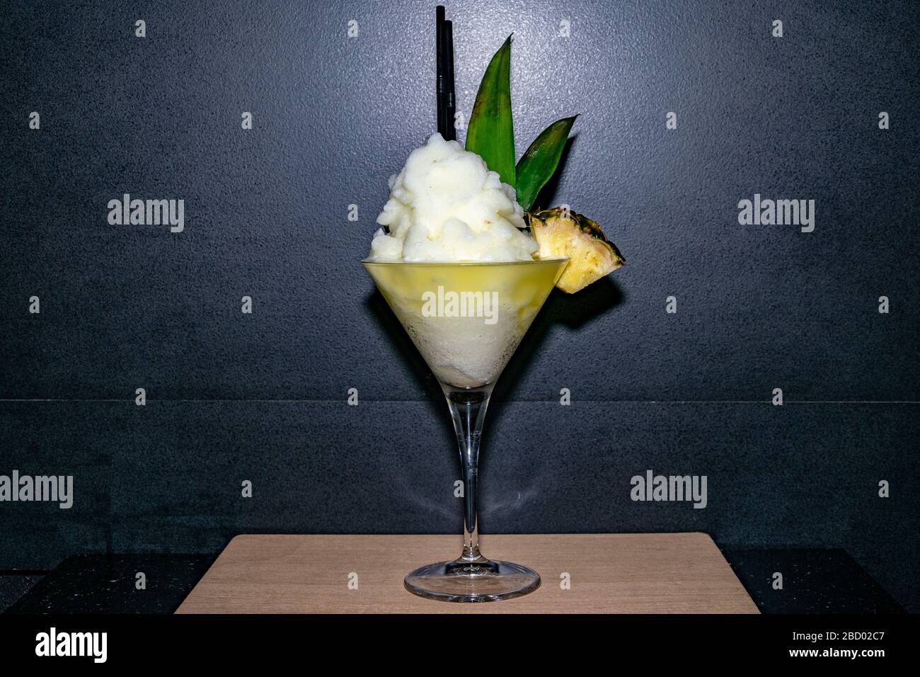 a frozen pina colada fruit cocktail served in a martini glass Stock Photo