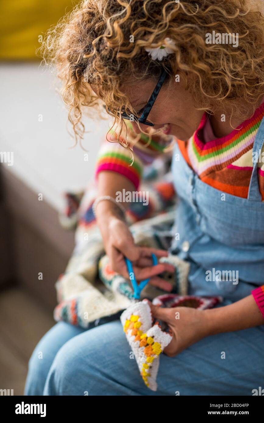 Artistic creative caucasian woman at home doing artwork and artcraft handmade - indoor leisure activity with textile fabric and colors - joyful lifest Stock Photo