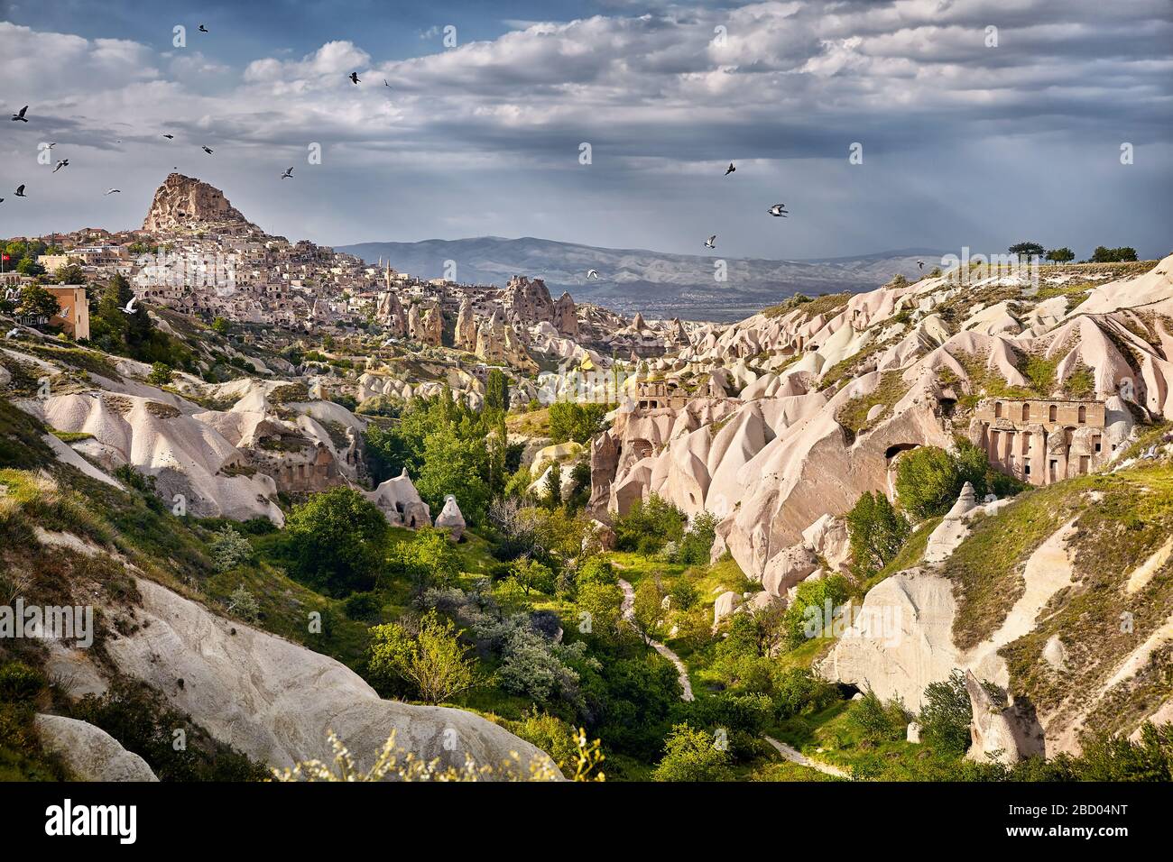 Uchisar castle and pigeon valley at cloudy sky in Cappadocia, Turkey Stock Photo