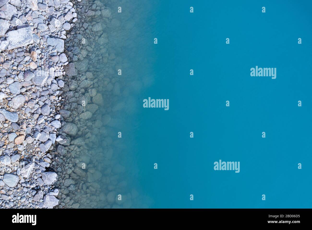 Aerial top view of turquoise lake and rocks abstract background at Tekapo, New Zealand Stock Photo