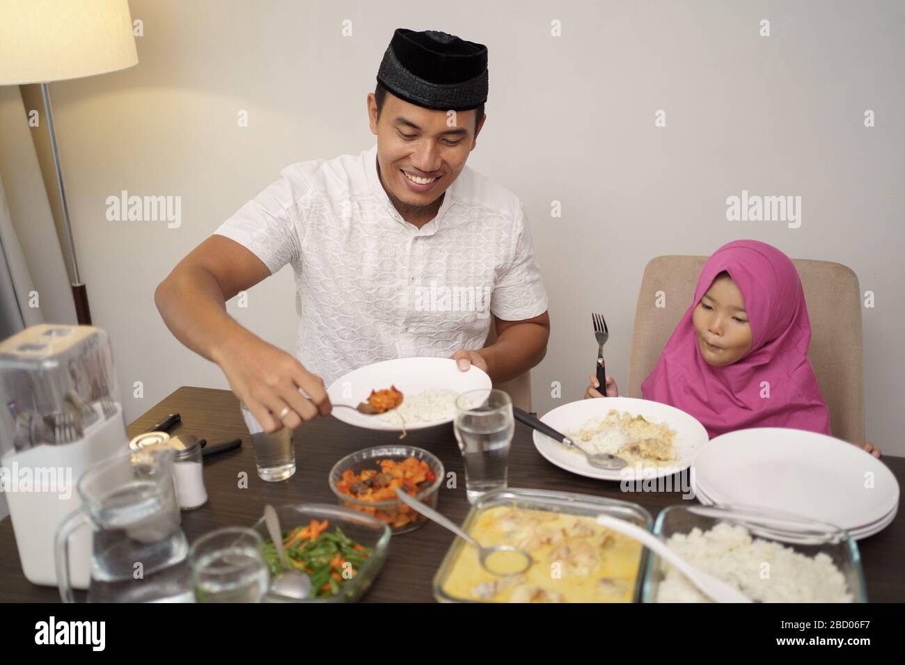 muslim family dinner break fasting together at home during ramadan Stock Photo