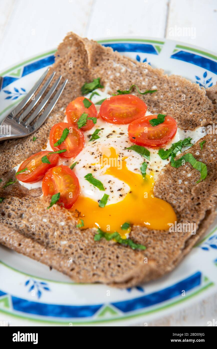 homemade breton crepe with egg and tomatoes Stock Photo