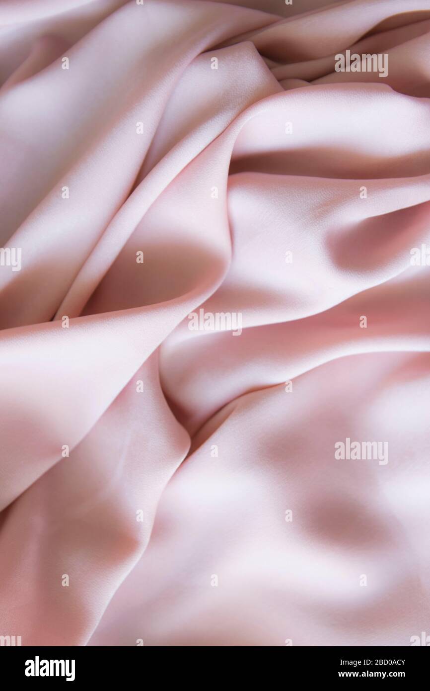 Silk pink gentle texture clothes. Textile cloth background. Stock Photo