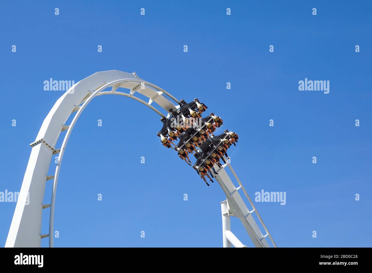 Rollercoaster Ride and loop against blue sky Stock Photo