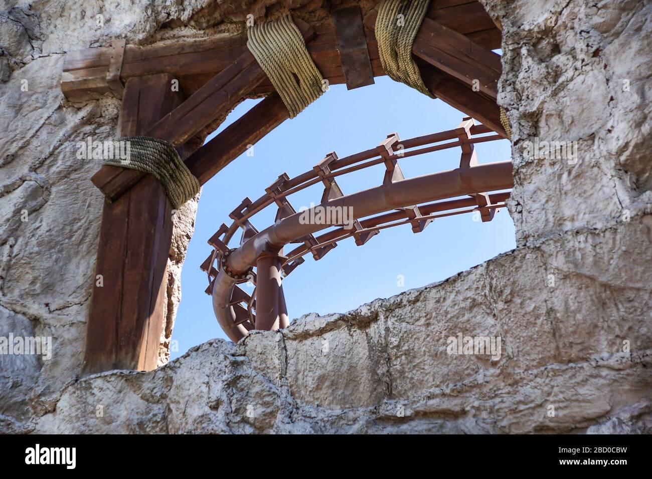 Roller coaster track leading into a mountain. rollercoaster amusement park Stock Photo