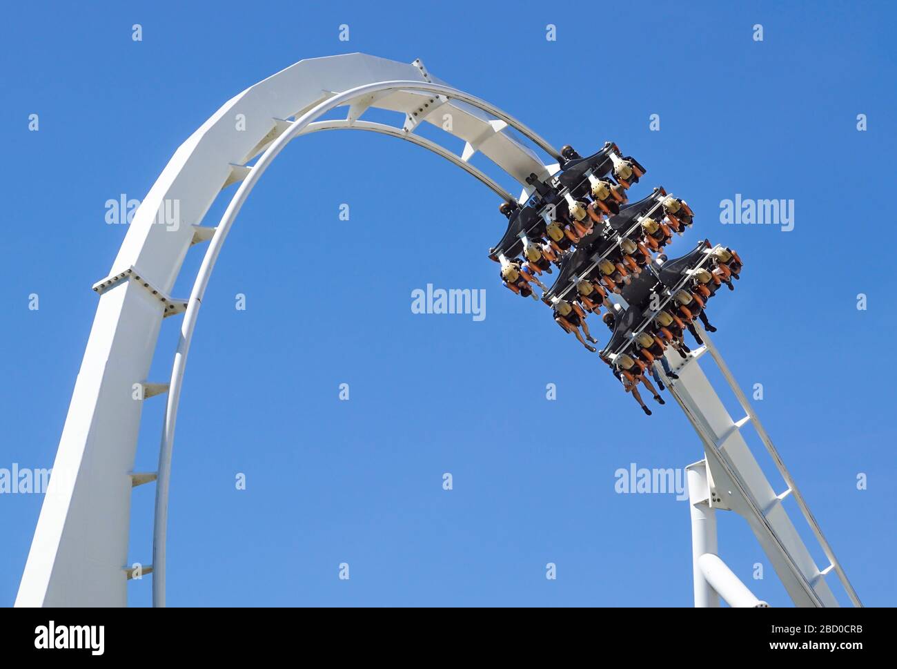 Rollercoaster Ride and loop against blue sky Stock Photo