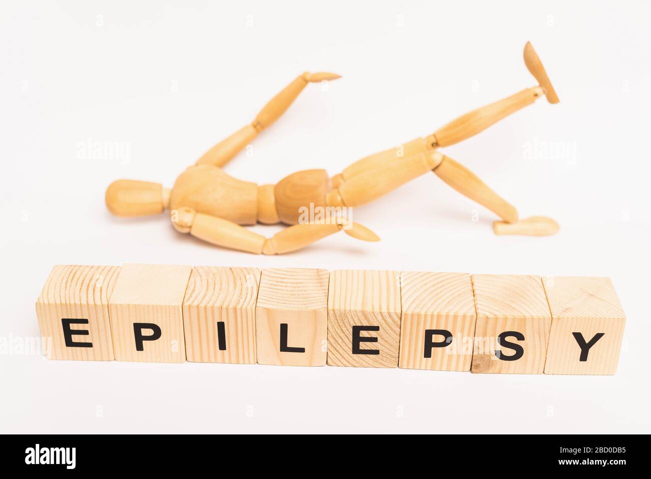 Selective focus of cubes with epilepsy lettering and wooden toy on
