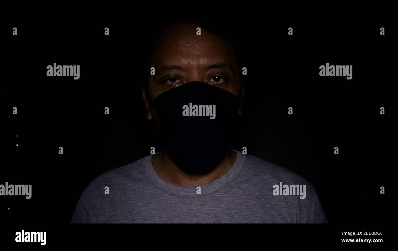 Wearing black mask hi-res stock photography and images - Alamy
