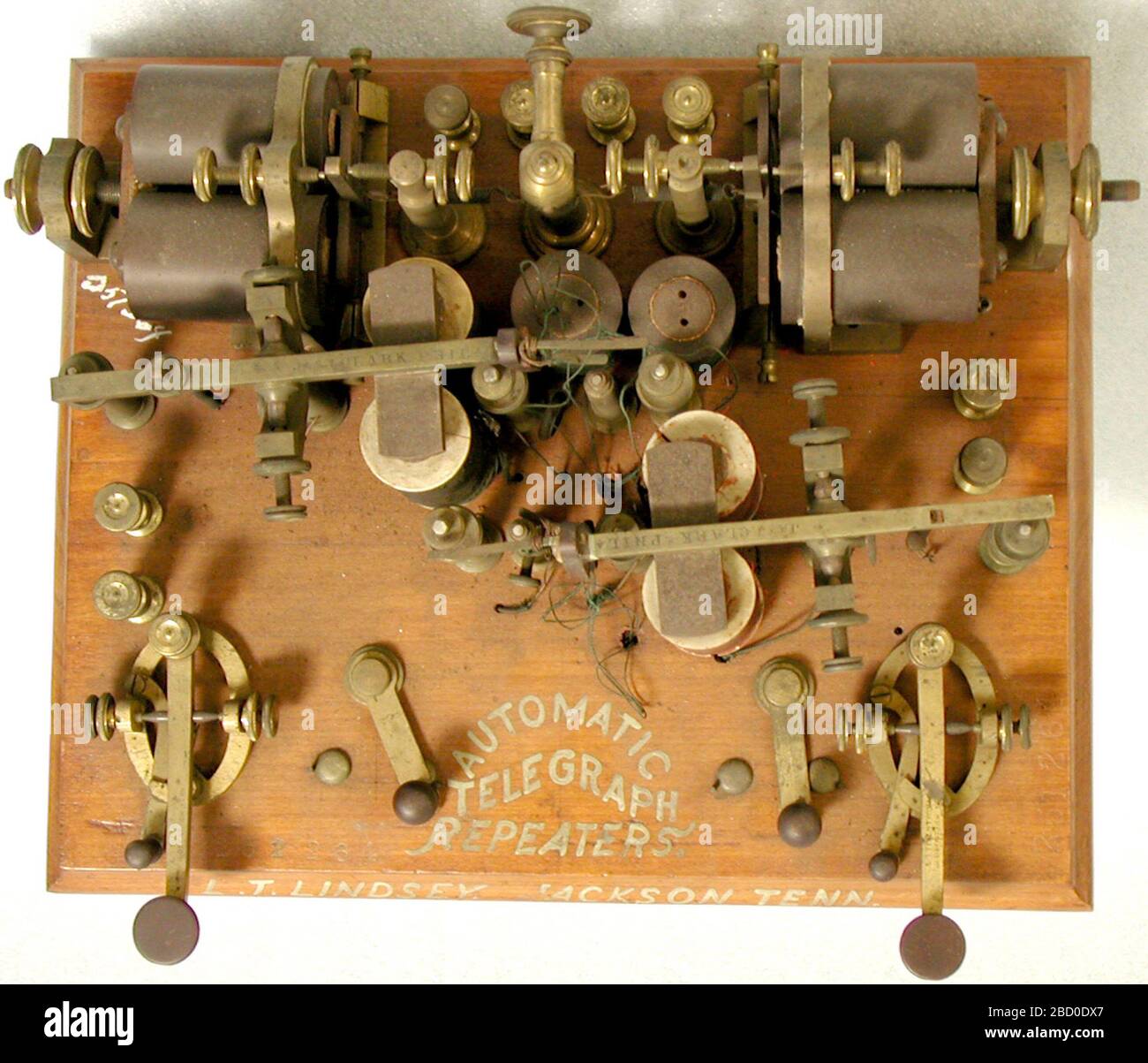 Lindsey telegraph repeater patent model. Telegraph repeaters amplified electrical signals in a telegraph line. Telegraph messages traveled as a series of electrical pulses through a wire from a transmitter to a receiver. Short pulses made a dot, slightly longer pulses a dash. NMAH2002-11467 Stock Photo