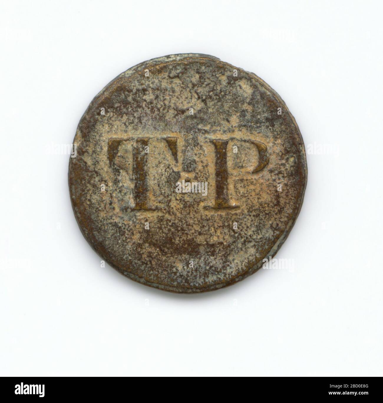 Identification button used by Thomas Porter II. A round copper-alloy button with the initials 'T*P' on the front. This button would have been sewn onto an enslaved person's shirt to identify him or her as belonging to Thomas Porter. Identification button used by Thomas Porter II Stock Photo