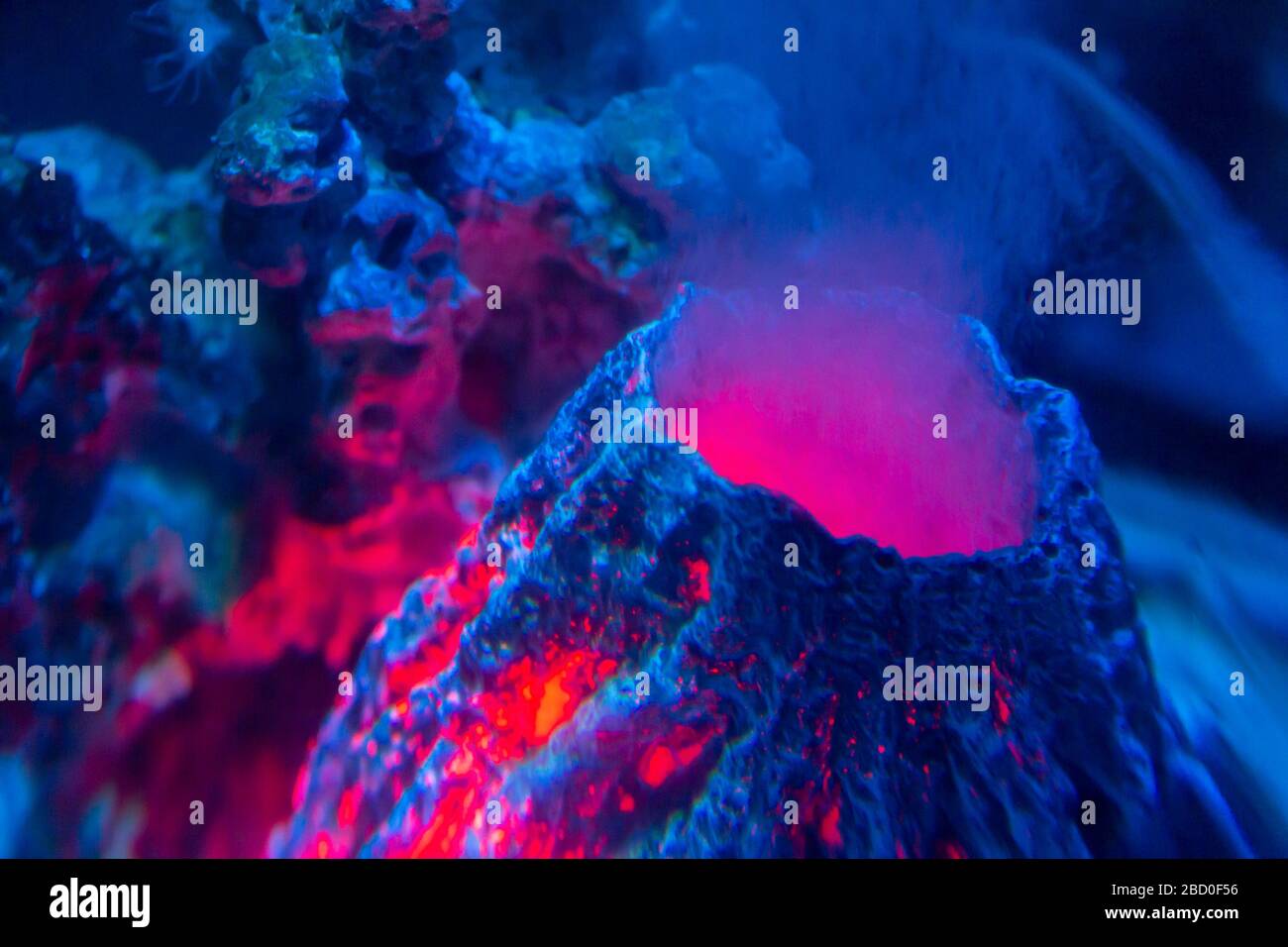 brightly illuminated artificial underwater volcano Stock Photo