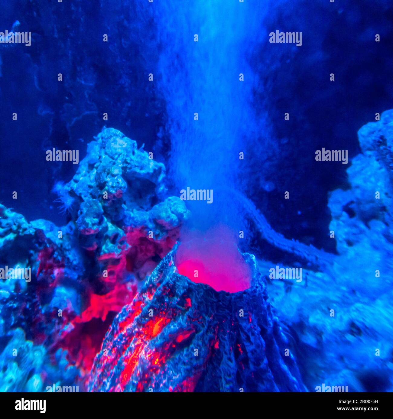 brightly illuminated artificial underwater volcano Stock Photo