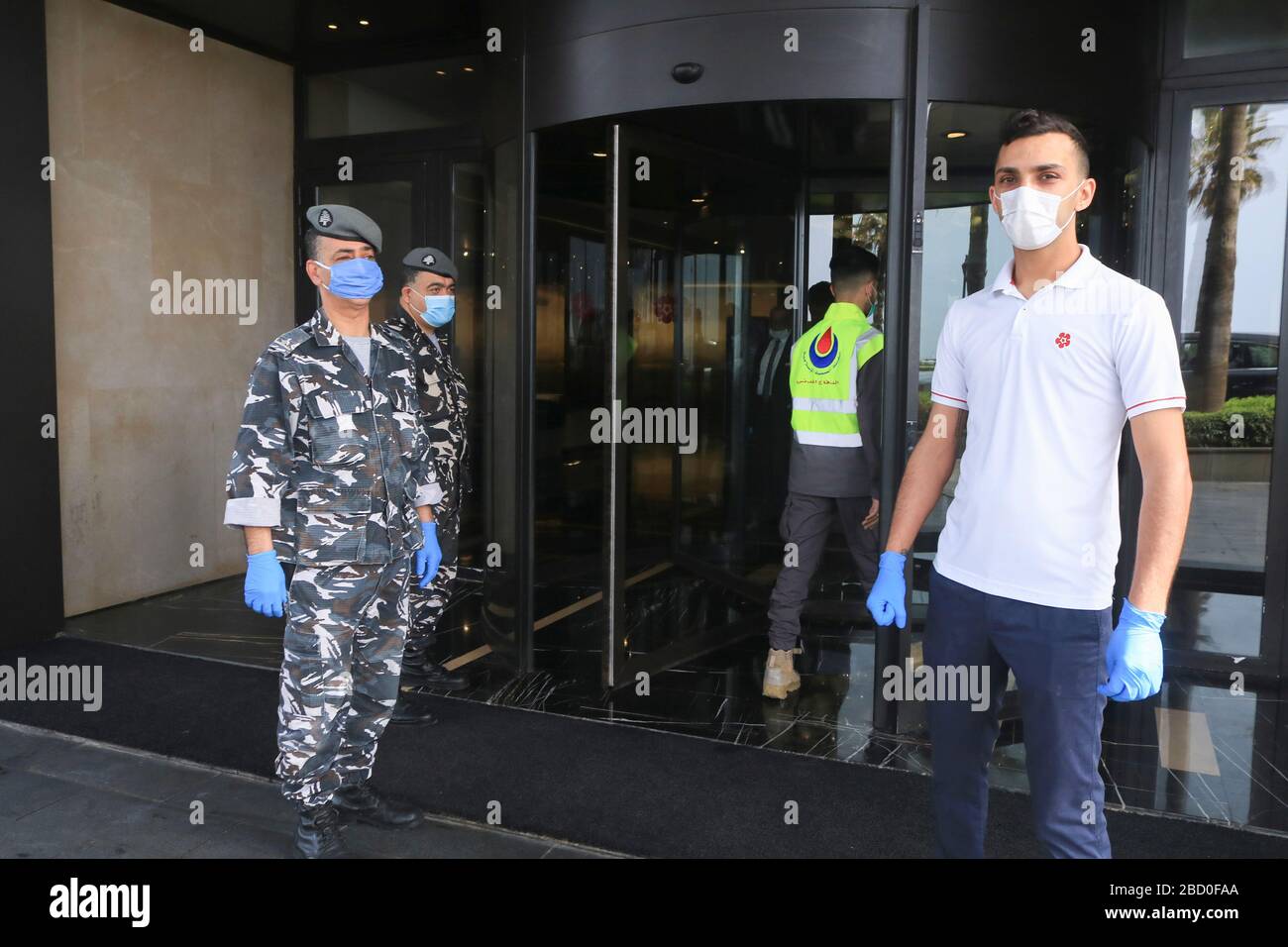 Beirut, Lebanon. 6 April 2020.Lebanese police wearing protective surgical masks and gloves against covid-19 infections guard the entrance to the Lancaster Plaza hotel in Beirut where Lebanese expatriates are being kept in quarantine after being flow in to Rafic Hariri aiport from Saudi Arabia, United Arab Emirates, Ivory Coast and Nigeria. Up to 20,000 citizens who are stranded overseas are expected to be flown in the next days: Credit: amer ghazzal/Alamy Live News Stock Photo