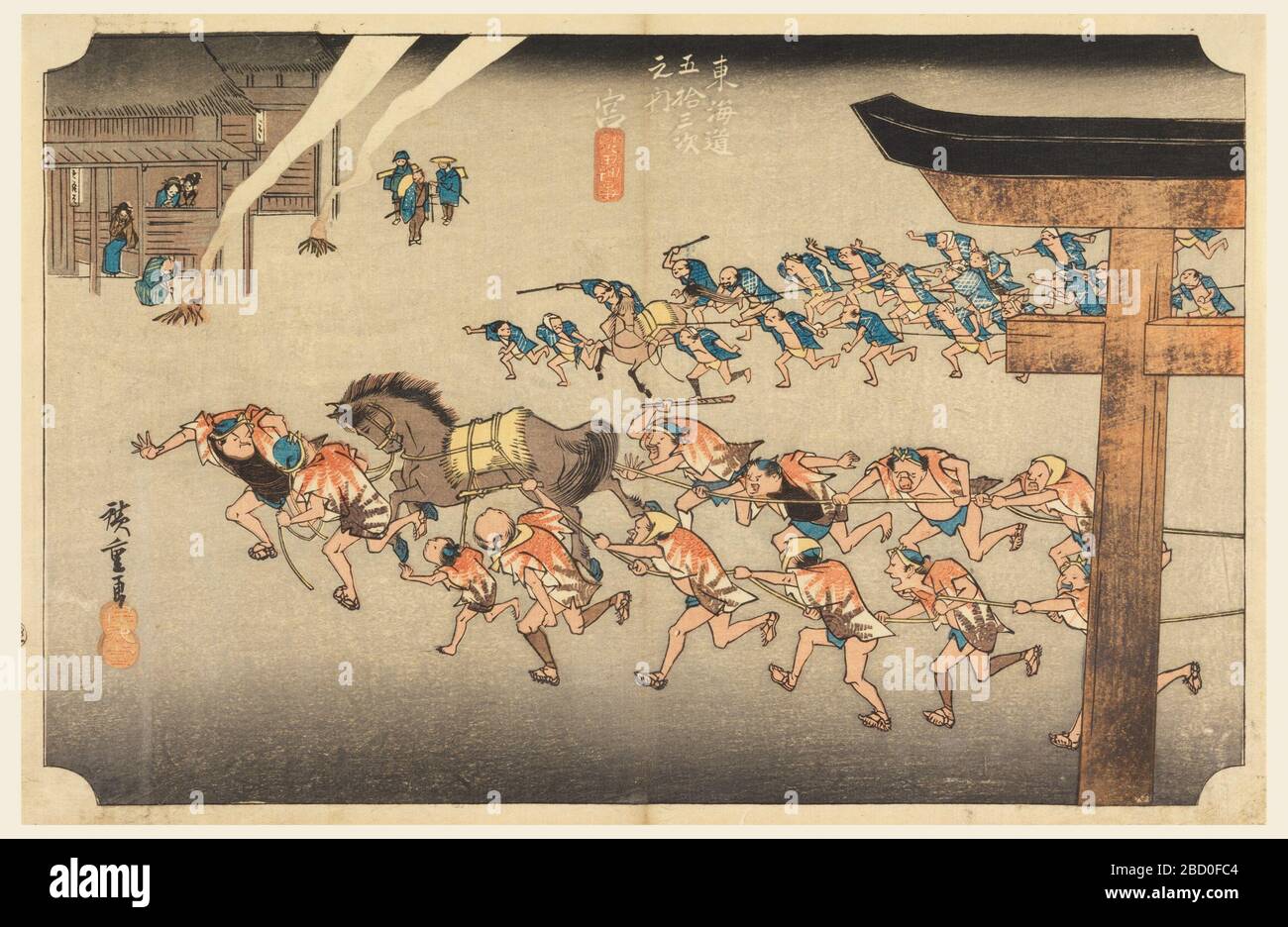 Miya Atsuta Jiuji Temple Fete in The FiftyThree Stations of the Tokaido Road Tokaido Gojusan Tsugino Uchi. Research in ProgressTwo teams of men, each with horse, hauling festival cars (not visible), from right to left. Right, part of Torii is seen. Left, building outside of which are two fires, and people watching activities. Miya Atsuta Jiuji Temple Fete in The FiftyThree Stations of the Tokaido Road Tokaido Gojusan Tsugino Uchi Stock Photo