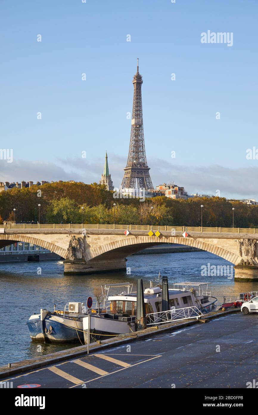 Eiffel tower and Seine river with boats in a sunny day in Paris, France Stock Photo