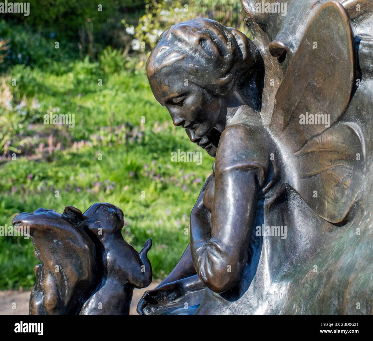 Peter Pan statue in Kensington Gardens, sculpted in bronze in 1912 by Sir George Frampton, showing detail of fairies who live in the Gardens. Stock Photo