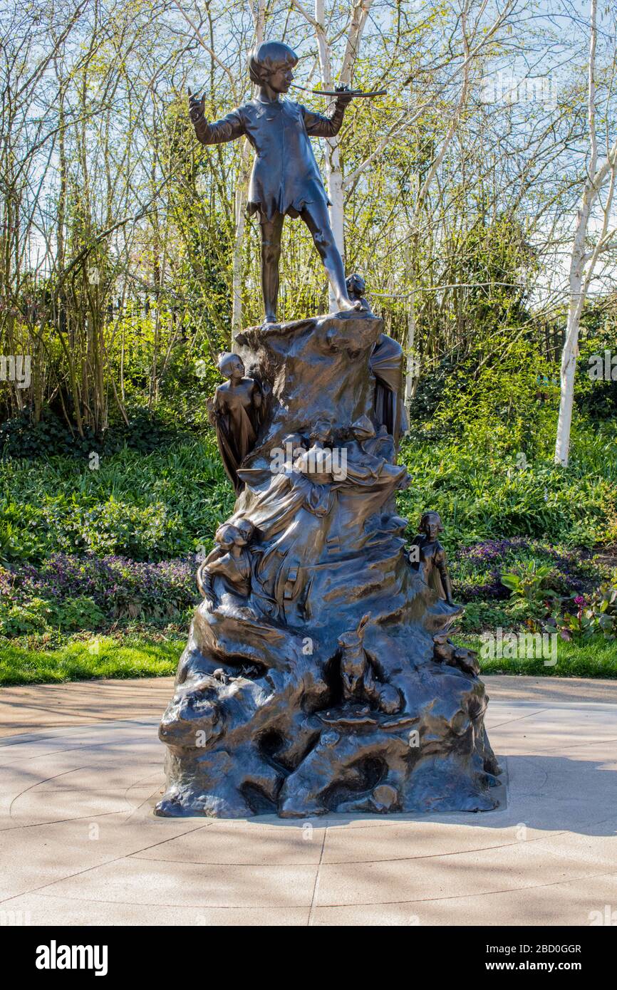Peter Pan statue in Kensington Gardens, sculpted in bronze in 1912 by Sir George Frampton. Stock Photo
