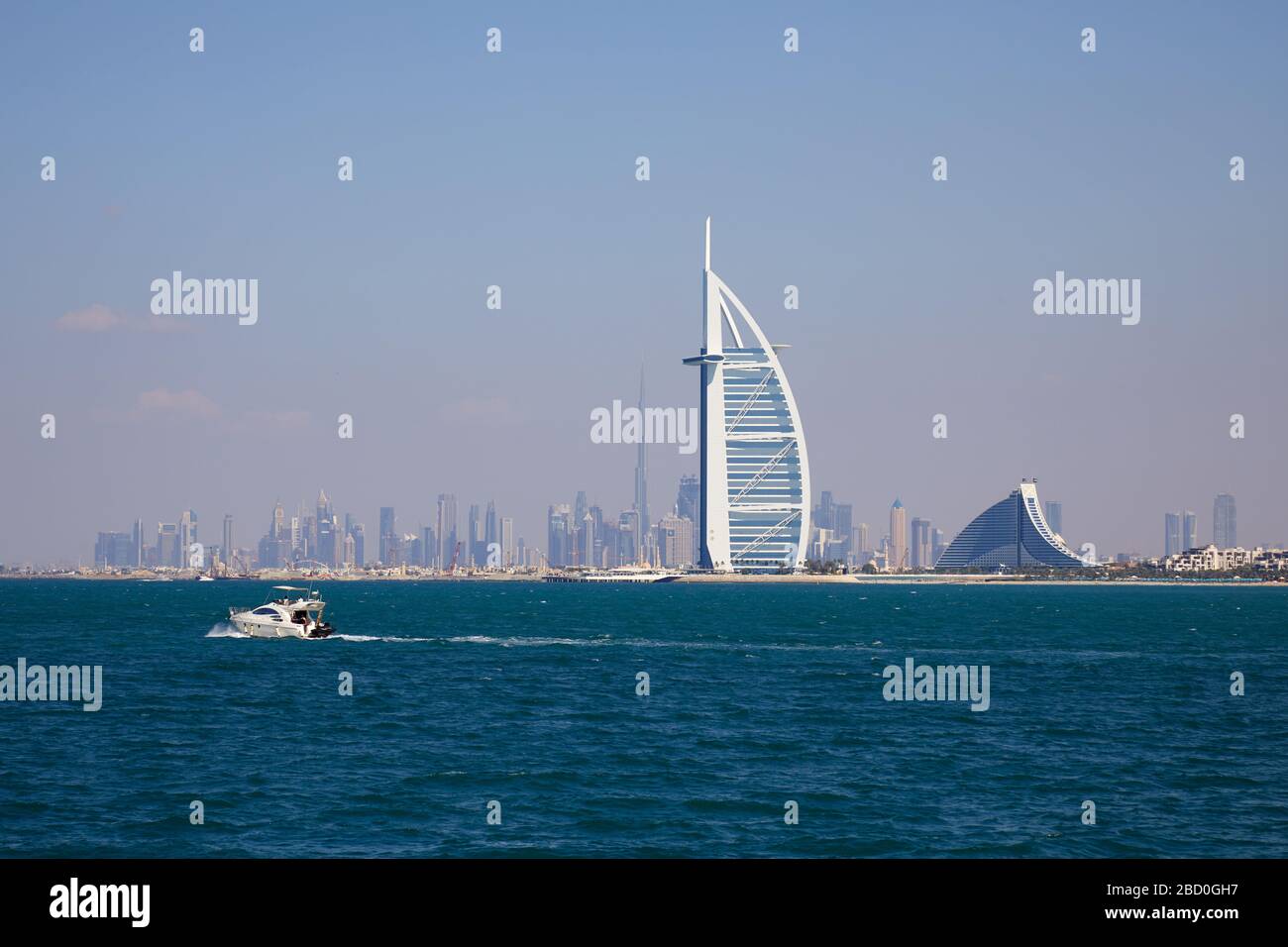 DUBAI, UNITED ARAB EMIRATES - NOVEMBER 22, 2019: Burj Al Arab luxury hotel and Dubai skyline with sea in a sunny day Stock Photo