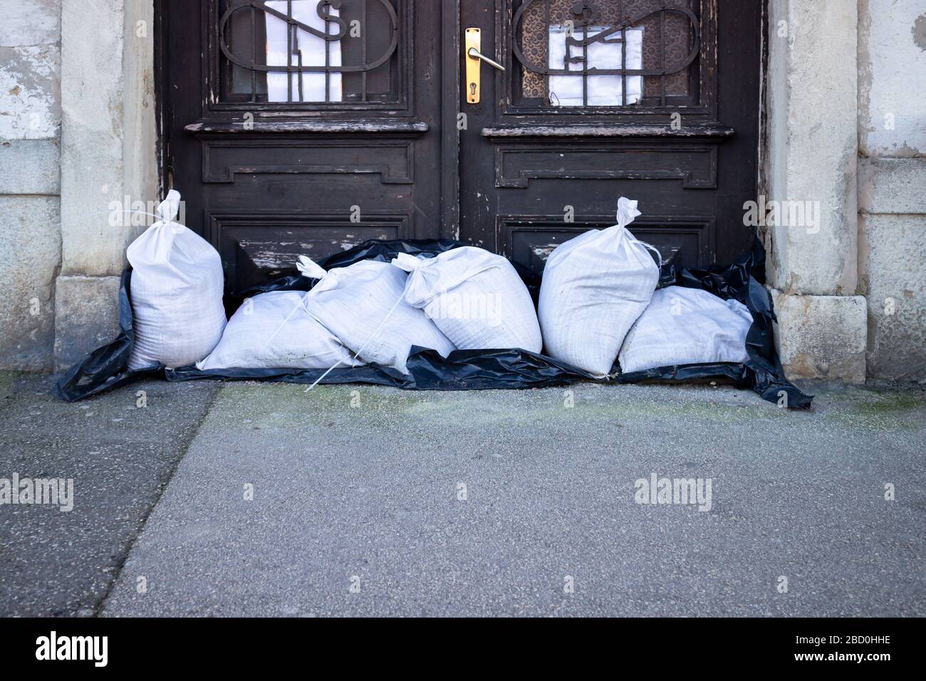 Sandbags stacked in front of doors to protect against flooding of river