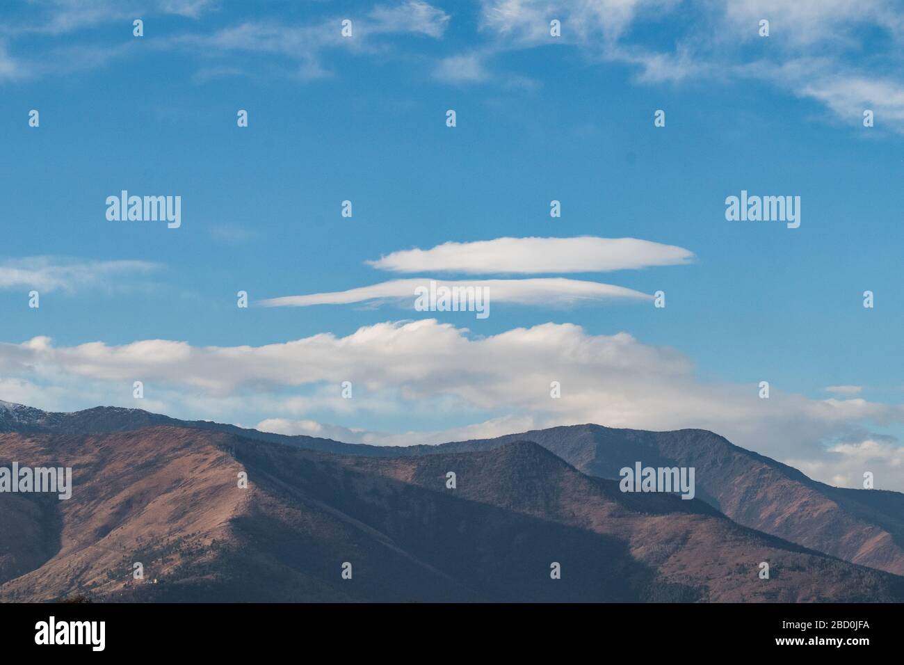 Peaceful mountain landscape with clear blue sky and white clouds hi-res ...