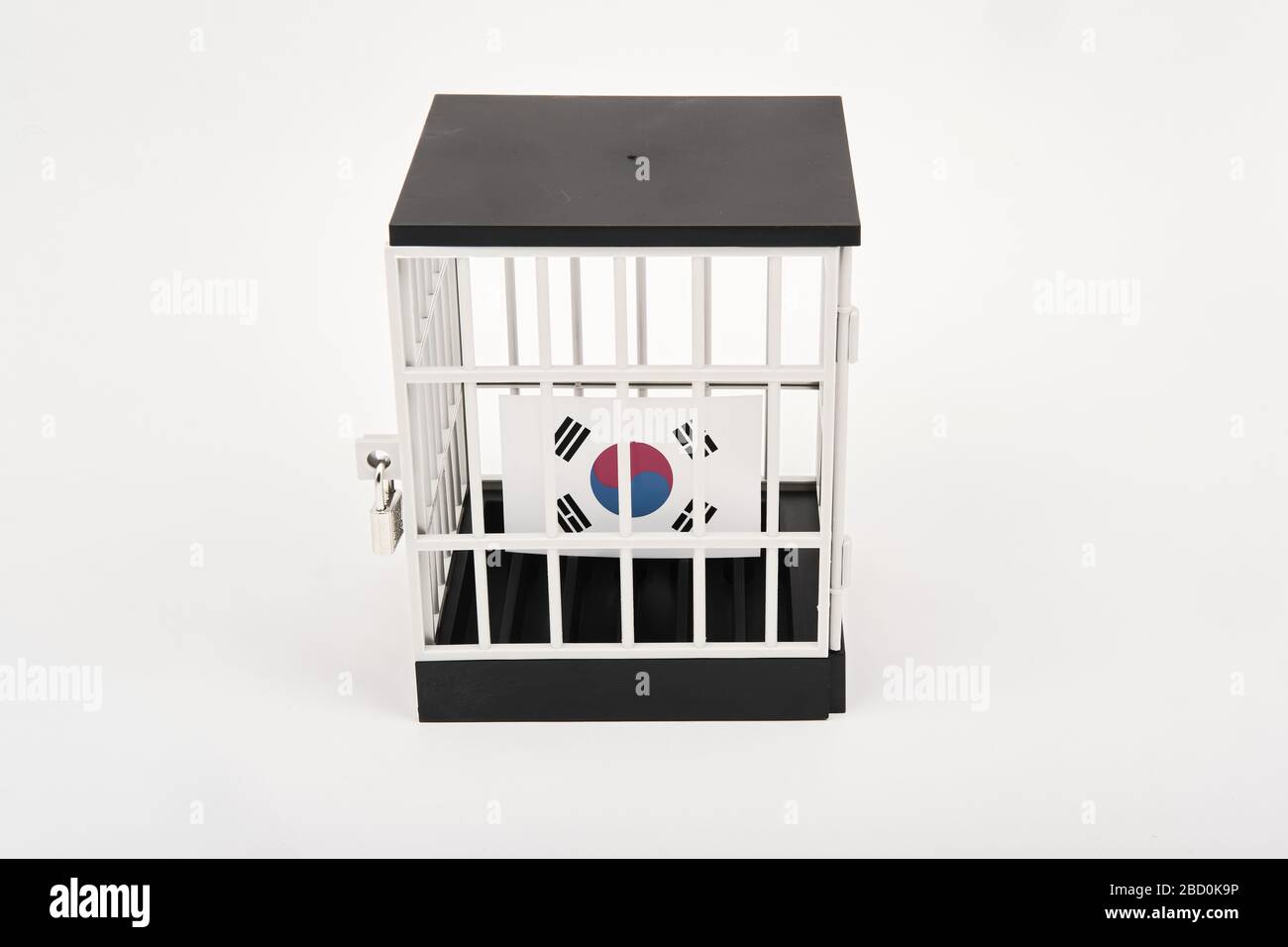 Coronavirus lockdown concept with South Korean flag inside padlocked jail Stock Photo