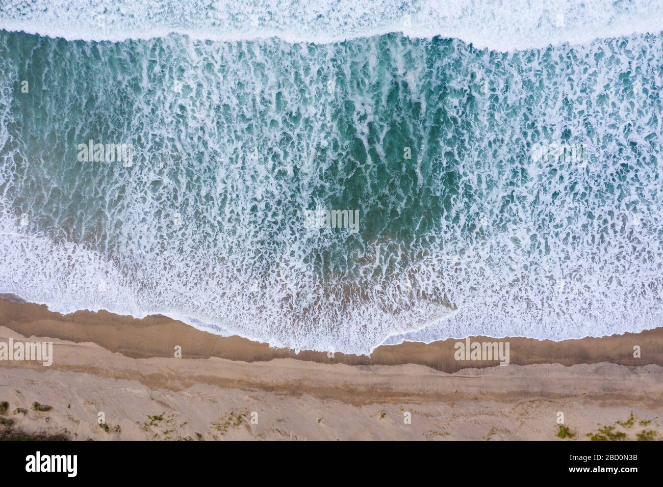 Sand dunes on the beach and ocean waves aerial drone top view Stock ...