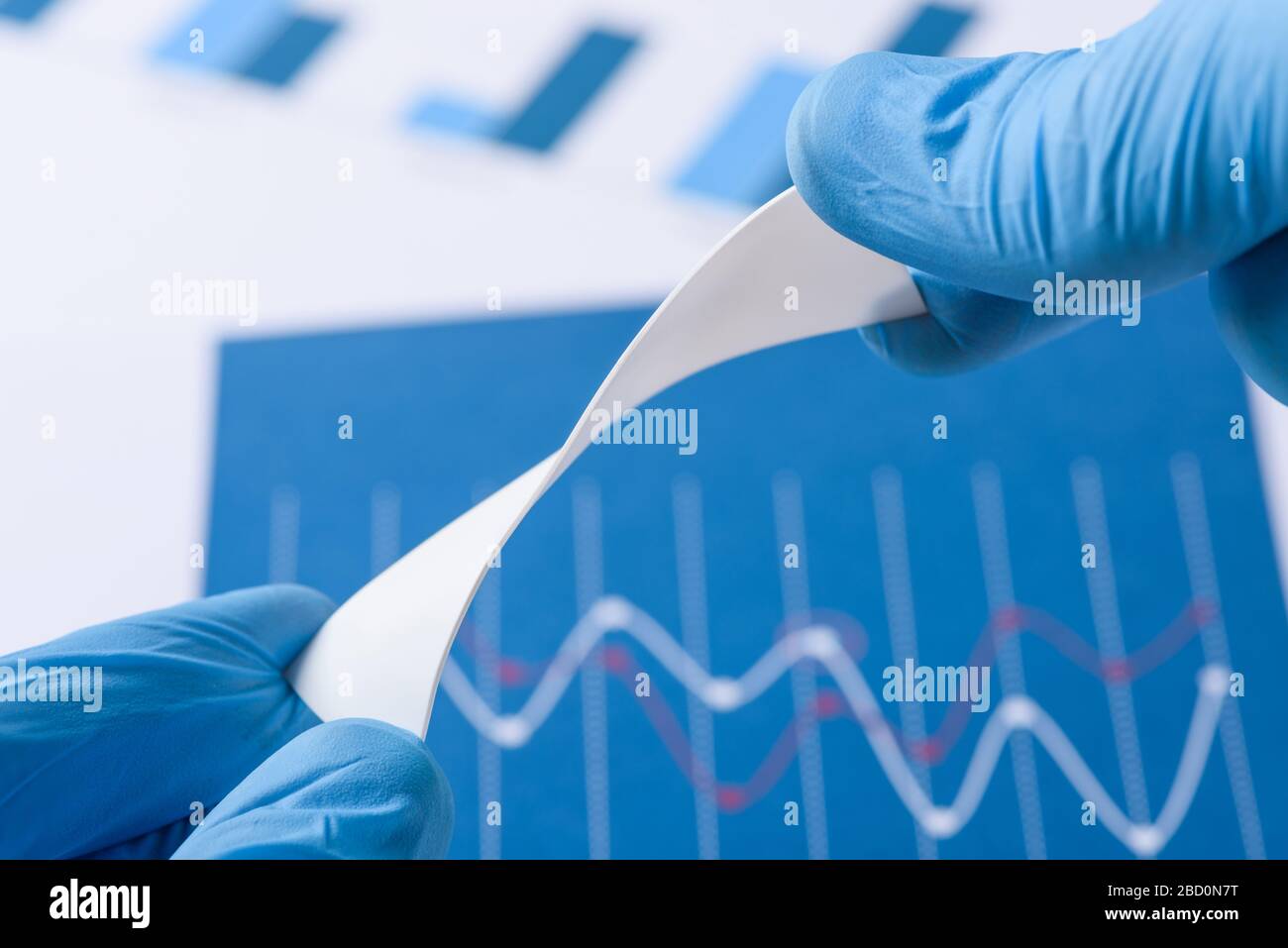 Novel flexible plastic material in scientist hands in laboratory concept Stock Photo