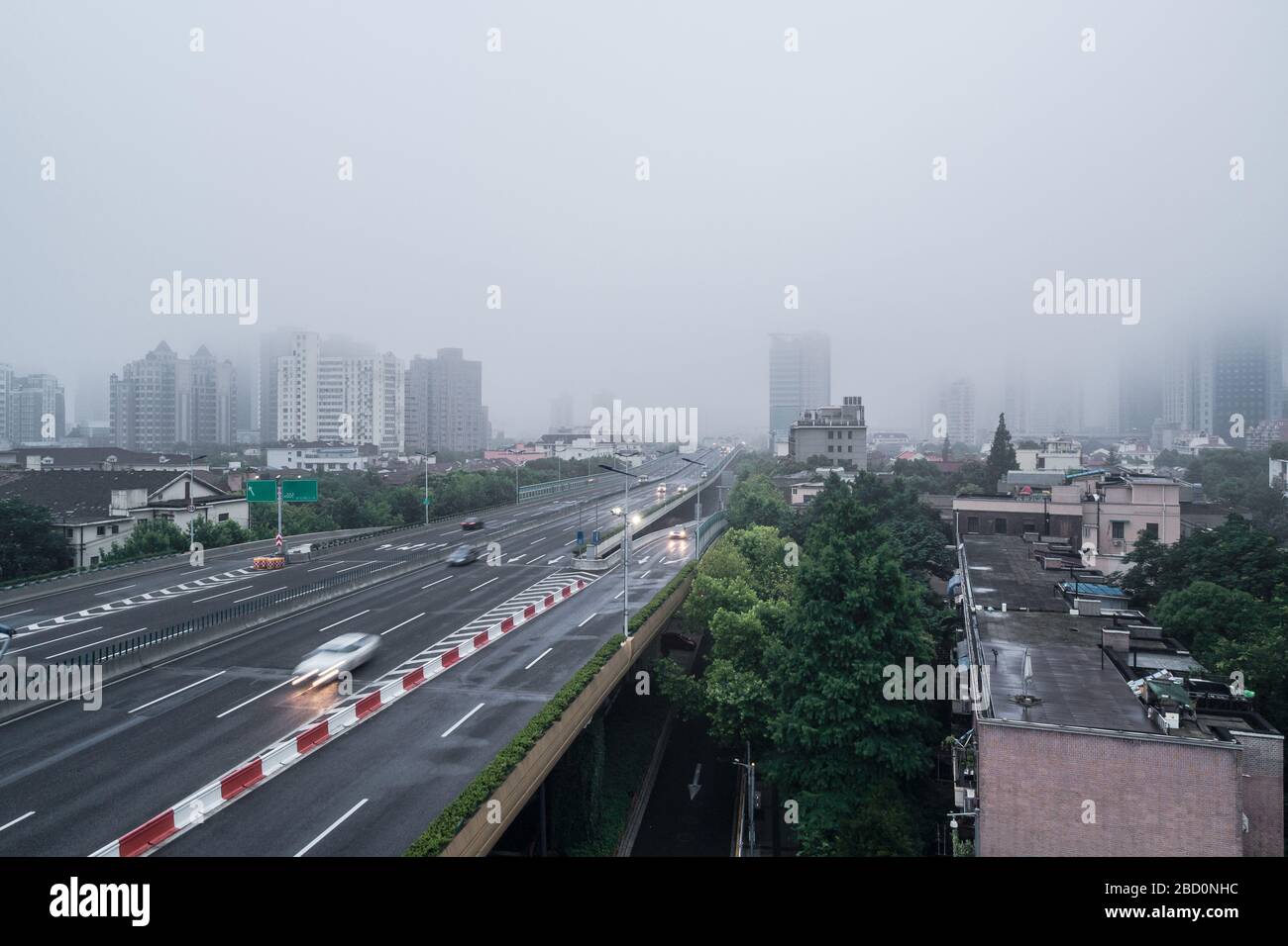 Aerial view of buildings and highway in the morning fog Stock Photo - Alamy