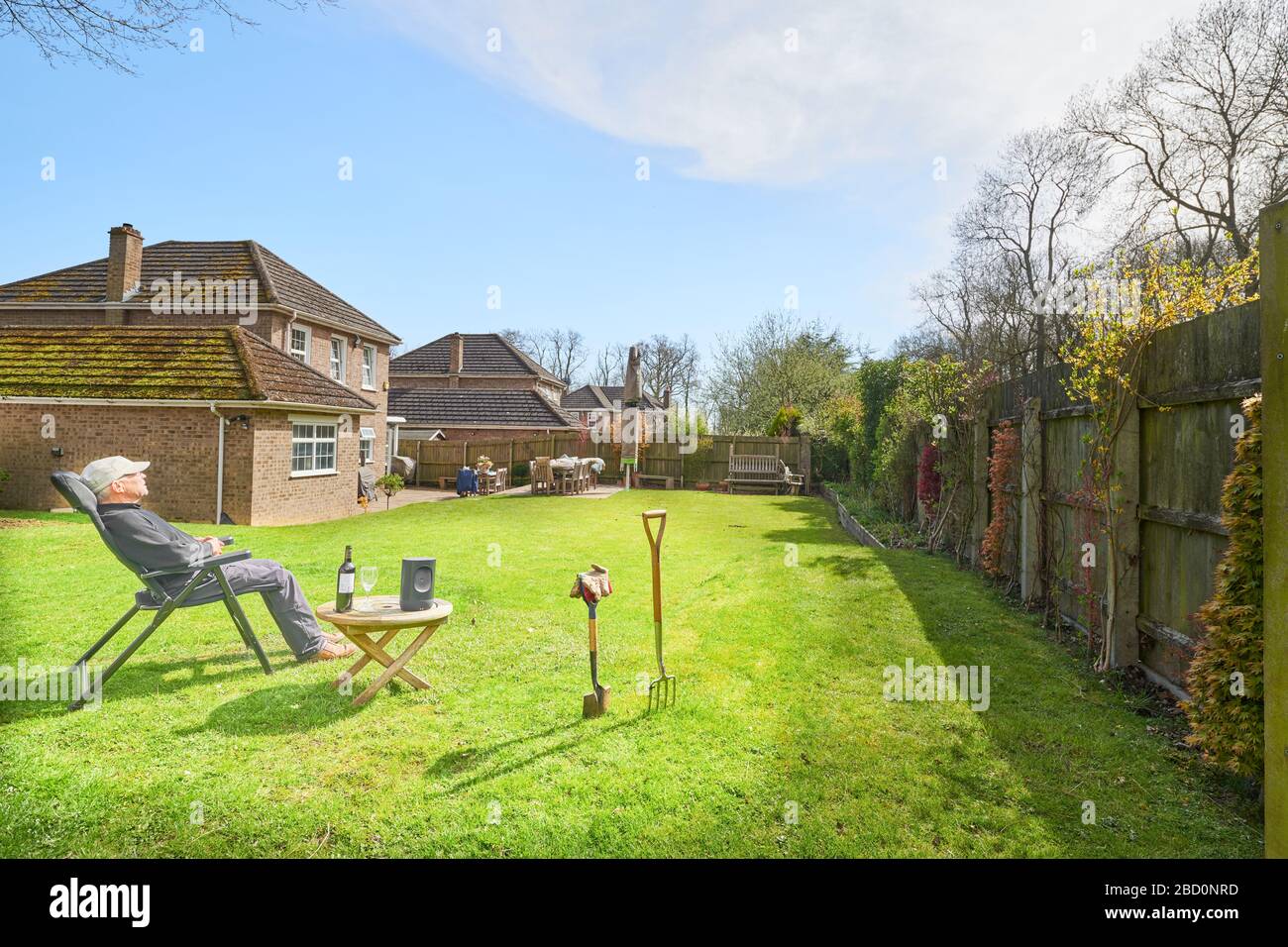 Enforced self-isolation initiated by the coronavirus lockdown, resulting in a relaxing and gardening on a sunny spring day. Stock Photo