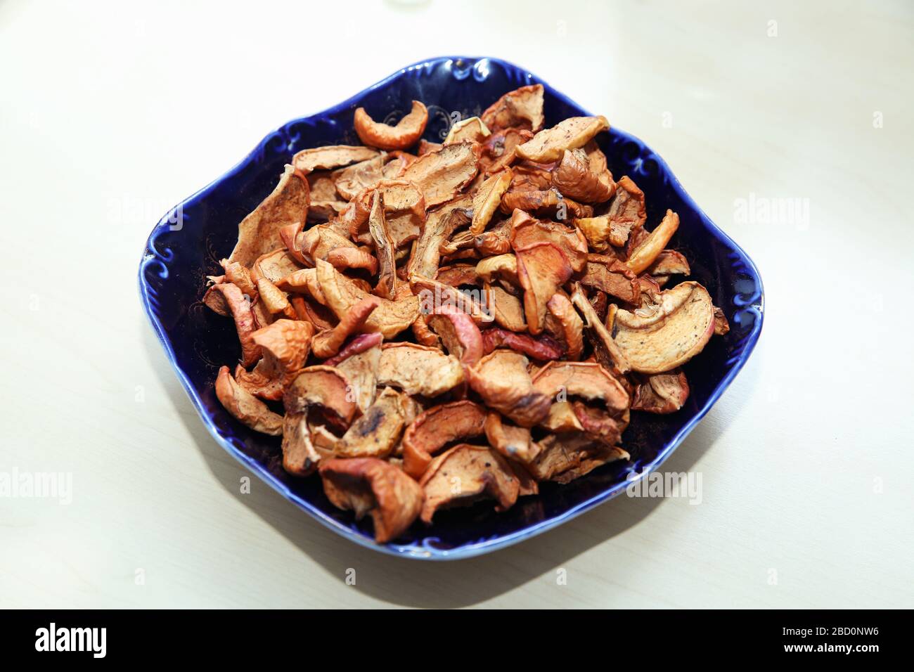 Dehydrated apples chips on plate, top view. Dried Apple chips in a