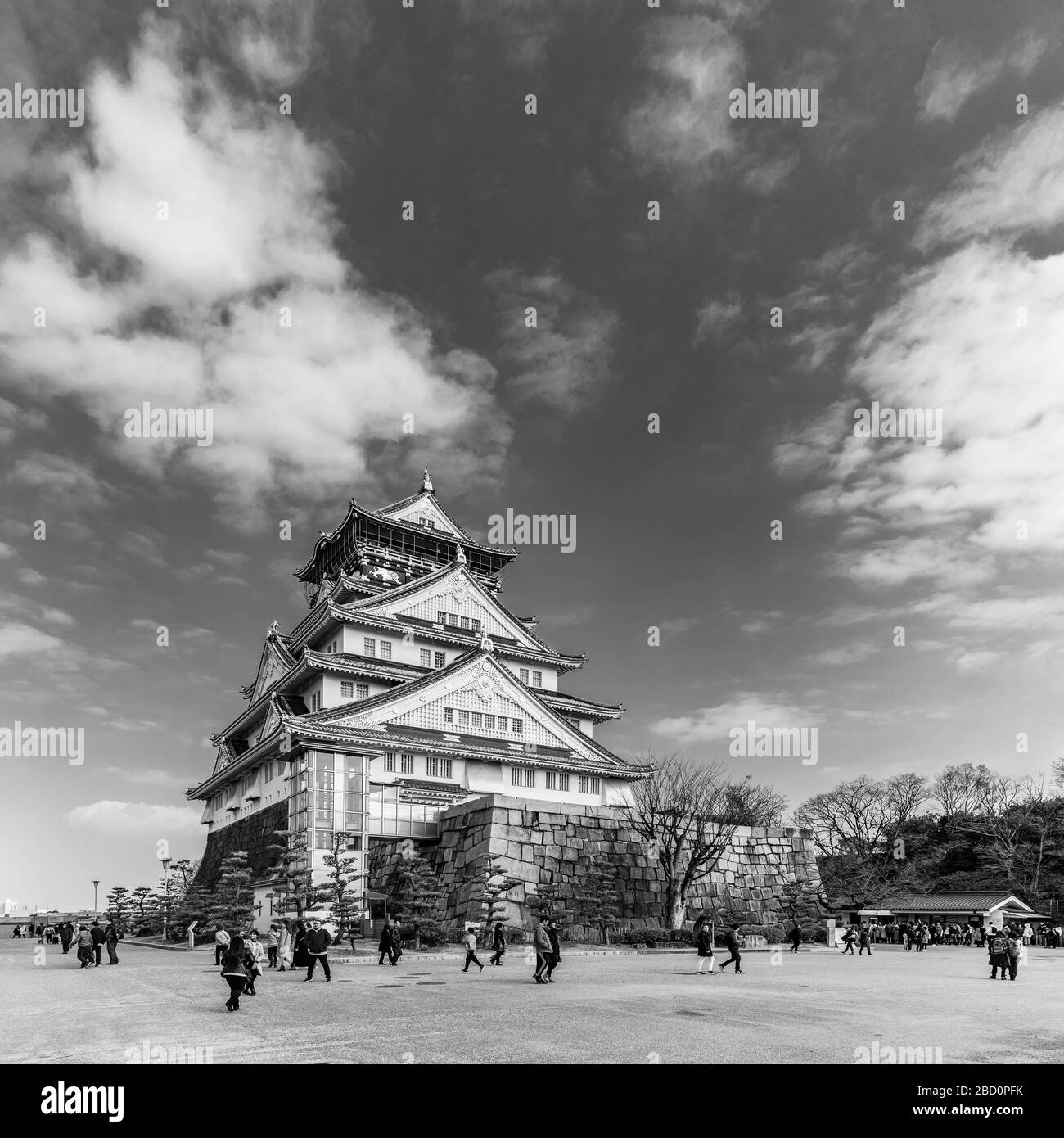 A black and white panorama picture of the Osaka Castle and the square around it. Stock Photo