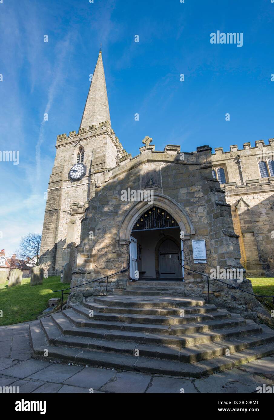 The entrance porch, tower and spire of St Peter and St Paul's church in Pickering, North Yorkshire Stock Photo