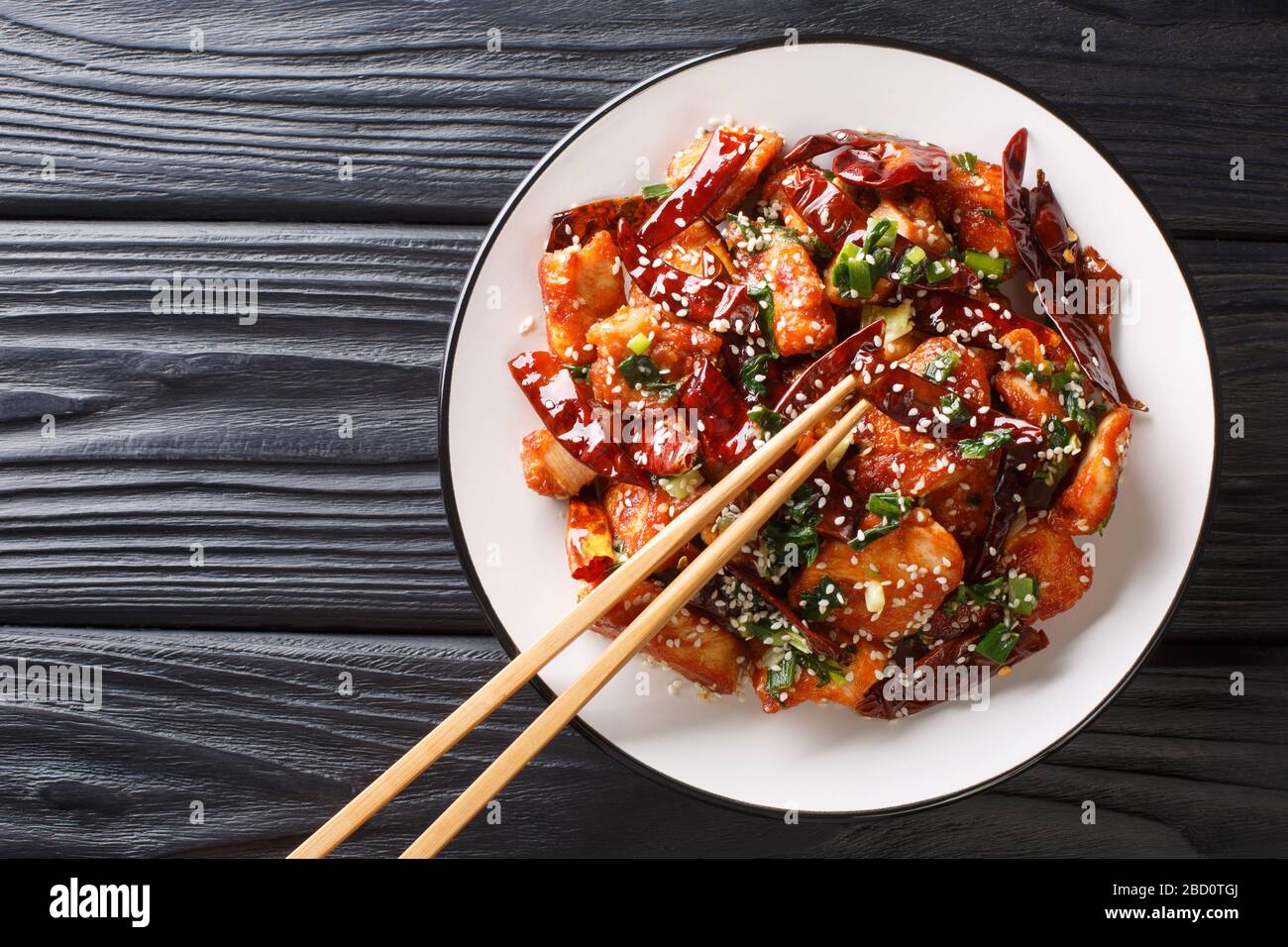 https://c8.alamy.com/comp/2BD0TGJ/chinese-mala-chicken-with-lots-of-sichuan-pepper-closeup-in-a-plate-on-the-table-horizontal-top-view-from-above-2BD0TGJ.jpg