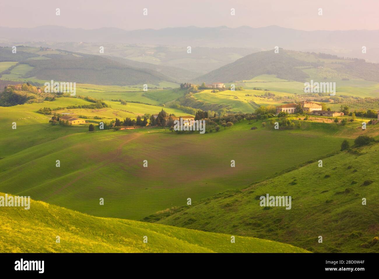 Italy, Tuscany, Volterra, Farms among Rolling Hills Stock Photo