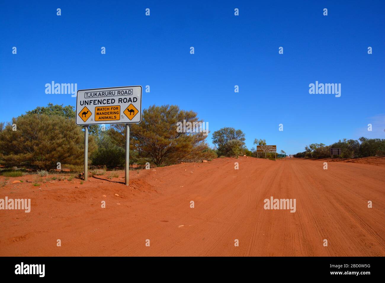 Wide angle view of the red dust road towards Western Australia with