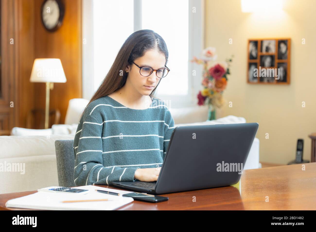 Teen girl with glasses studying with laptop at home Stock Photo - Alamy
