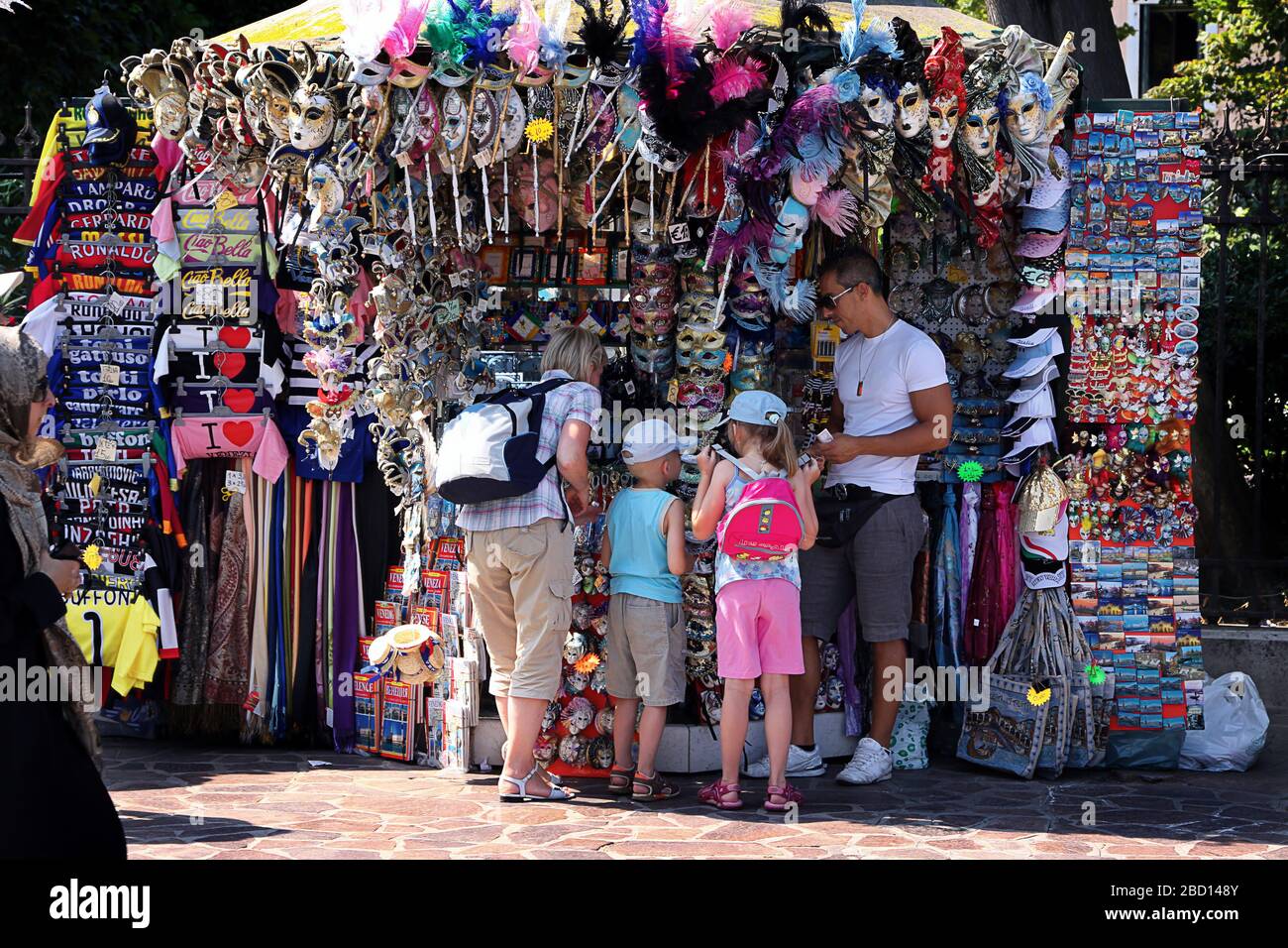 Italy, Venice - 13 June 2019: Souvenir booth in Venice, tourists buy gifts for the family Stock Photo